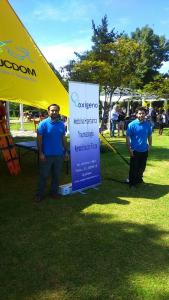 Gerardo Burboa y Claudio Romero en el stand de Oxígeno junto a pendón en el III Festival de Menores 2015 